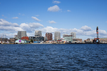 Panoramic view from the IJ river to NDSM neighborhood (Amsterdam-Noord borough), located on the former terrain NDSM-wharf, along the IJ river. AMSTERDAM, The NETHERLANDS.