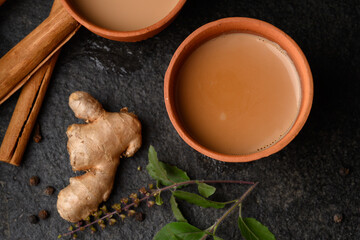 Earthen tea cup or Chai in kulhad with Ginger, Cardamom  Cinnamon tulsi