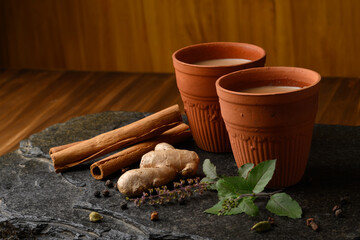 Earthen tea cup or Chai in kulhad with Ginger, Cardamom  Cinnamon tulsi