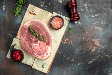 Raw pork ham cut on a dark background, banner, menu, recipe place for text, top view