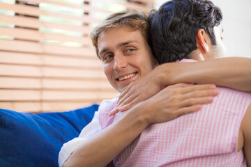 LGBTQ gay couple doing activities together at home and socializing together happily.