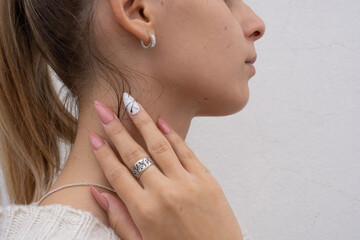 face in profile showing pink sculpted nails