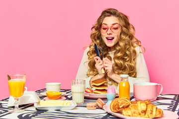 Bright emotional girl wearing pink sunglasses holding cutlery and looking at food with exciting...