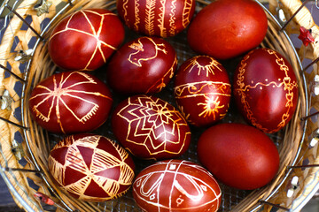Easter eggs top view. Closeup of basket of colored red eggs, Easter holiday concept. Collection of pysanka or krashanka. Close up. Out of focus
