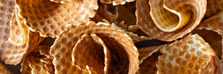 Background of waffle cones, delicious confectionery pastry, waffle cone for ice cream, top view.