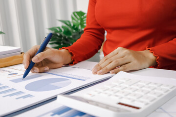 Close-up shot of busy woman paying bills online on computer to calculate household finances or taxes on the machine.