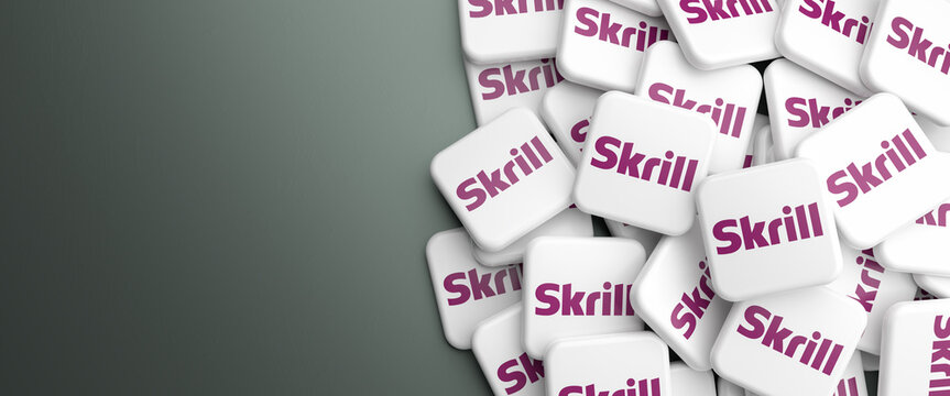 Logos of the payment solution Skrill (formerly Moneybookers) on heap on a table. Web banner format, copy space