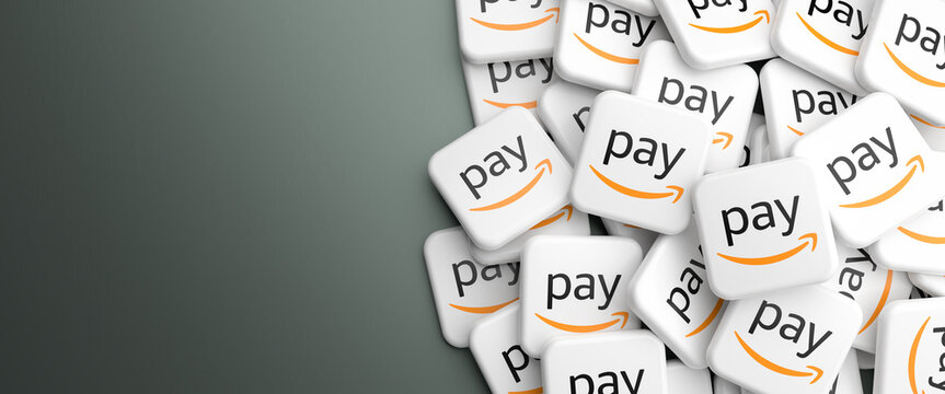 Logos of the payment solution Amazon Pay on heap on a table. Web banner format, copy space