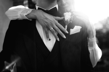 A loving couple, hand in hand, celebrate their wedding day in elegant attire