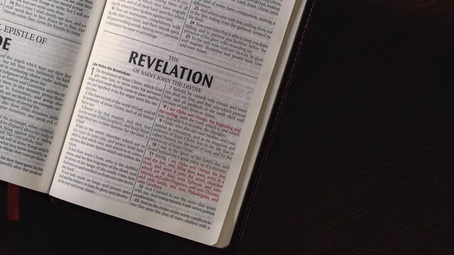 Open Bible chapter John Revelation camera movement with light trail cirlcing the title