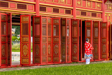 Vietnam, Red wooden doors of  the The To Mieu Temple. In the Forbidden City or the Imperial City in Hue.