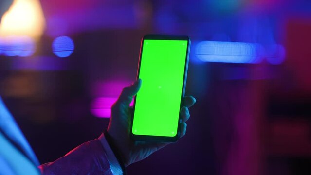 Neon metaverse futuristic concept. modern woman with smartphone blank green screen.