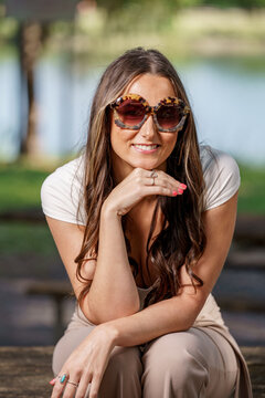 Fashionable young woman posing with oversized sunglasses