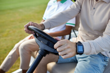 Close up of unrecognizable rich man driving golf cart with focus on hands holding wheel, copy space