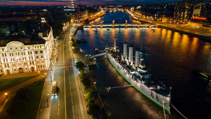 Fototapeta na wymiar Aerial view of the warship Aurora in historical and at the same time modern city of St. Petersburg on a summer night