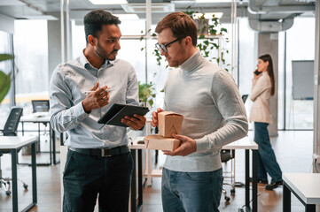 Having the business conversation. Men and woman are working in the office together