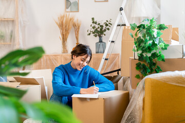 Young woman taking notes in clipboard