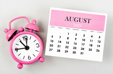 The August 2023 Monthly calendar year with alarm clock on gray colour background.