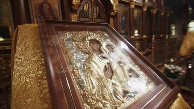 Icon of the Mother of God on the lectern in front of the iconostasis in the orthodox church. Slow motion