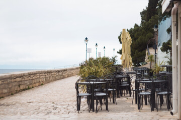 Fototapeta na wymiar Beautiful cafe on the beach of Adriatic sea coast Croatia in historic city Rovinj Croatia Istria