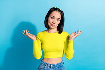 Photo of young model korean funny girl shrug shoulders no idea misunderstanding dont know other languages isolated on blue color background - obrazy, fototapety, plakaty