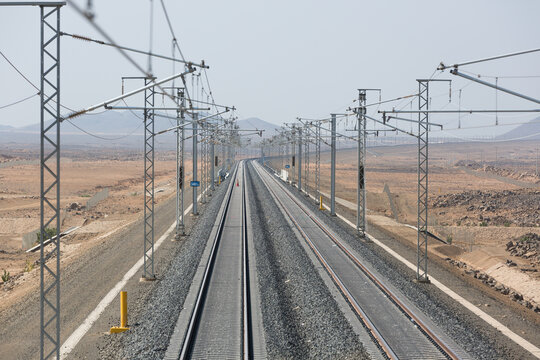 Railroad with powerlines under construction in summertime