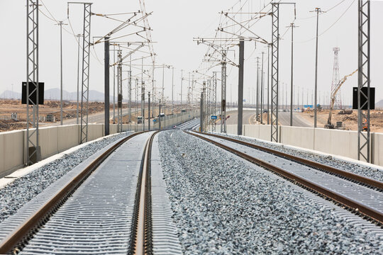 Railroad with powerlines under construction in summertime