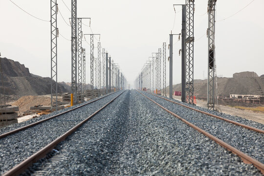 Railroad with powerlines under construction in summertime