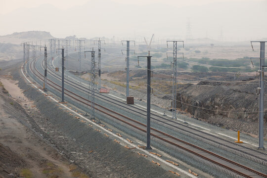 Railroad with powerlines under construction in summertime