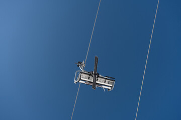 Vertical shot of  cableway cabin with a skier