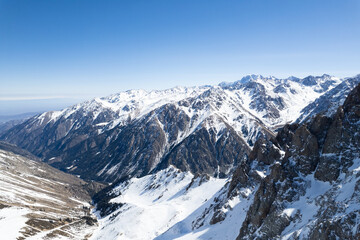 Aerial shot of a grand snow covered mountain range