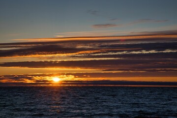 Fototapeta na wymiar Beautiful shot of a sunset over a sea with calm waves