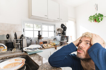 Man complaining about his messy kitchen in the morning. Close up to his face.