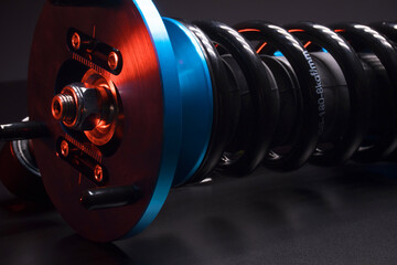 auto suspension tuning coilovers shock absorbers and springs blue for a sports drift car on a dark background