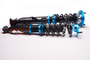 auto suspension tuning coilovers shock absorbers and springs blue for a sports drift car on a dark...
