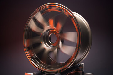 sports matte bronze car rims illuminated by red light photography at various long shutter speeds for the effect of motion blur when rotating