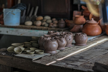 Hands working sculpture on pottery wheel ,making hands shaping a bowl pottery on the spinning,mold,...