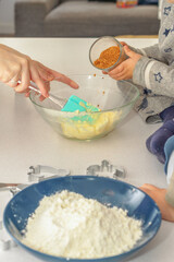 children with their mother preparing a cake
