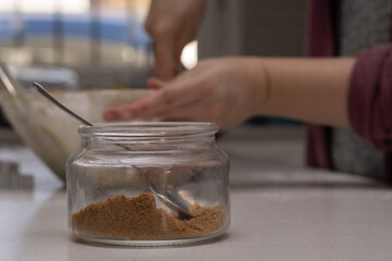 glass jar with brown sugar and a spoon
