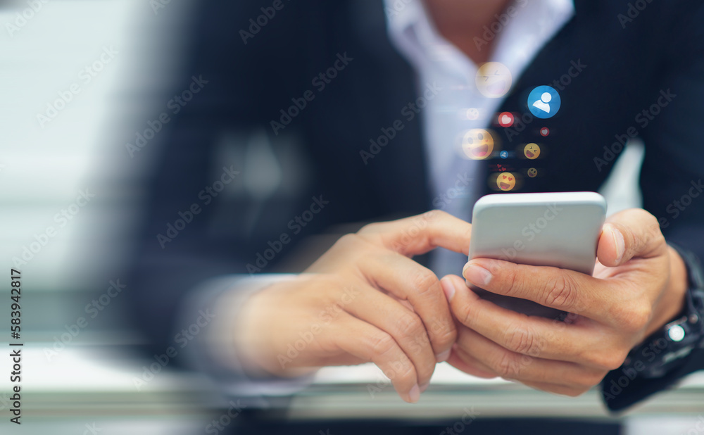 Poster close-up of a businessman using his smartphone, hands holding it and typing while the action is blur