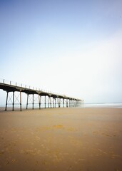 Vertical shot of the pier at the North Yorkshire seaside town of Saltburn-by-the-Sea on a misty day