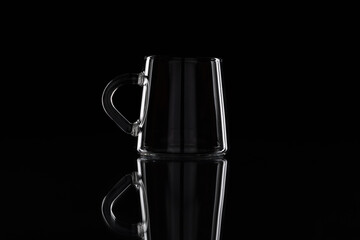 Glass coffee cup on the dark background. Low key photo.