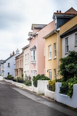 Vertical shot of a row of colorful houses along riverside under cloudy sky