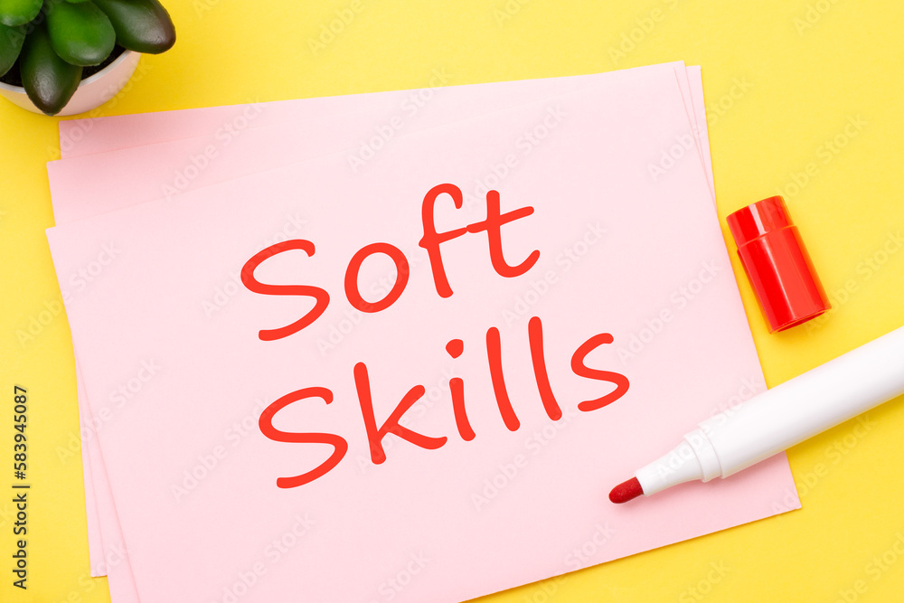 Poster pink business card with soft skills text stands on a yellow background with red marker