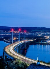 Fototapeta na wymiar Drone shot of the traffic light trails over Kessock Bridge after dark in Inverness, Scotland, UK