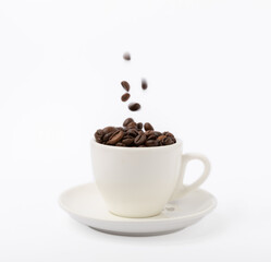 A cup of aromatic espresso coffee isolated on a white background. Coffee beans in a cup. Energy drink. A refreshing aromatic morning drink.
