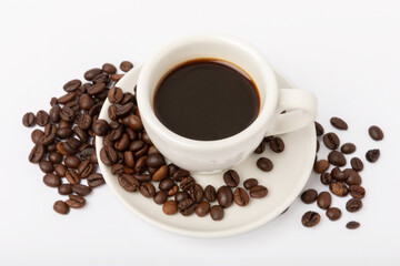 A cup of aromatic espresso coffee isolated on a white background. Coffee beans in a cup. Energy drink. A refreshing aromatic morning drink.