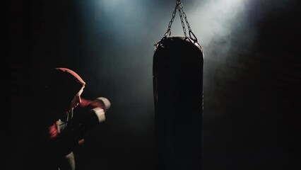 Top view Fighter's silhouette, trinity in the gym - hits a boxing pear