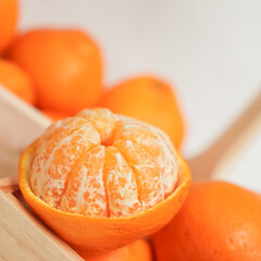 Ripe juicy orange tangerine whole in peel and slices isolated on white background with copy space, flat lay clipping path