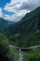 Fototapeta na wymiar Vertical shot of a bridge over a fjord in the mountains of Kinsarvik, Norway